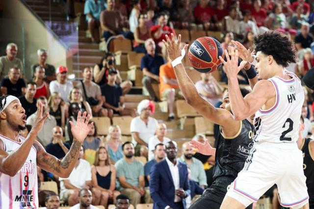 AS Monaco's French guard #00 Elie Okobo (2ndR) fights for the ball with Paris Basketball's French-Algerian guard #02 Nadir Hifi (R) next to Paris Basketball's US power forward #09 Lamar Stevens (L) during the French Ligue Nationale de Basket (LNB Elite) Pro A final match between AS Monaco Basket and Paris Basketball, at the Gaston Medecin arena in Monaco on June 21, 2026. (Photo by Valery HACHE / AFP)