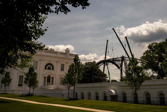 Workers disassemble The Claw from the UFC Freedom 250 fight on the South Lawn of the White House, in Washington, DC on June 21, 2026. (Photo by Kent Nishimura / AFP)