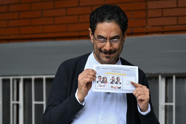 Colombia's presidential candidate for the ruling Pacto Historico party, Ivan Cepeda, shows his ballot as he votes at a polling station during the presidential election runoff, in Bogota on June 21, 2026. Colombians head to the polls to pick a new president between a hard-right White House-backed lawyer and a leftist senator that will decide the fate of the country's stumbling peace process and strained ties with Washington. (Photo by Raul ARBOLEDA / AFP)