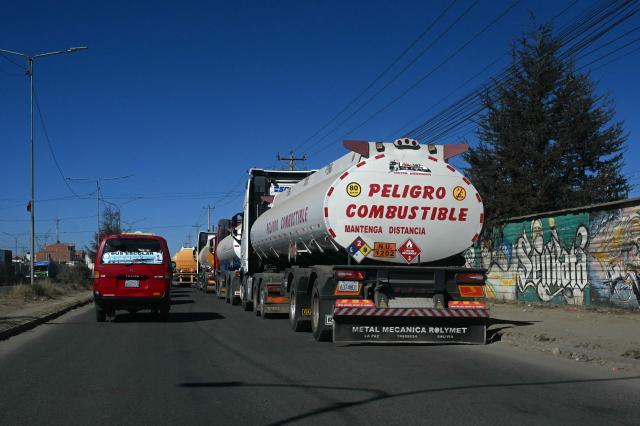 Tank trucks drive in the road linking Desaguaderos-La Paz, in Laja, Bolivia, on June 21, 2026, a day after Bolivia's President Rodrigo Paz declared a state of emergency. Bolivian police driving bulldozers cleared highways and fuel trucks rolled into La Paz after the president declared a state of emergency to remove anti-government roadblocks promoted by unions, Indigenous groups, and coca growers that had paralyzed the Andean nation for more than six weeks. (Photo by AIZAR RALDES / AFP)