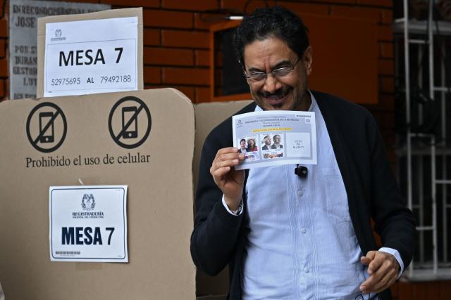 Colombia's presidential candidate for the ruling Pacto Historico party, Ivan Cepeda, shows his ballot as he votes at a polling station during the presidential election runoff, in Bogota on June 21, 2026. Colombians head to the polls to pick a new president between a hard-right White House-backed lawyer and a leftist senator that will decide the fate of the country's stumbling peace process and strained ties with Washington. (Photo by Raul ARBOLEDA / AFP)