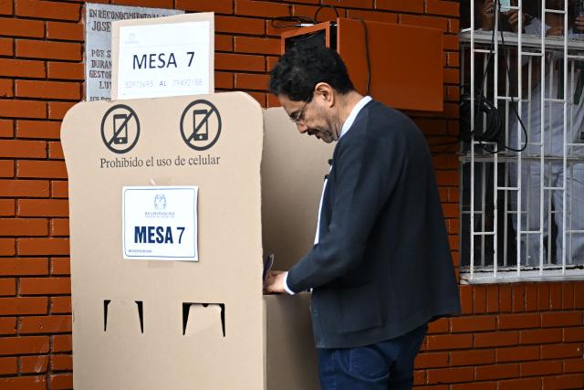 Colombia's presidential candidate for the ruling Pacto Historico party, Ivan Cepeda, votes at a polling station during the presidential election runoff, in Bogota on June 21, 2026. Colombians head to the polls to pick a new president between a hard-right White House-backed lawyer and a leftist senator that will decide the fate of the country's stumbling peace process and strained ties with Washington. (Photo by Raul ARBOLEDA / AFP)
