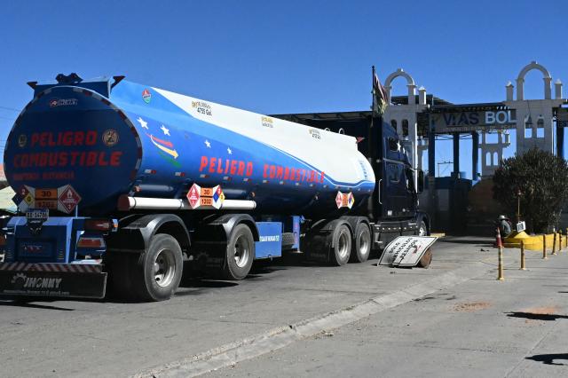 Tank trucks cross a toll in the road linking Desaguaderos-La Paz, in Laja, Bolivia, on June 21, 2026, a day after Bolivia's President Rodrigo Paz declared a state of emergency. Bolivian police driving bulldozers cleared highways and fuel trucks rolled into La Paz after the president declared a state of emergency to remove anti-government roadblocks promoted by unions, Indigenous groups, and coca growers that had paralyzed the Andean nation for more than six weeks. (Photo by AIZAR RALDES / AFP)