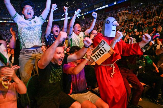 Supporters of the Team Falcons celebrate during the grand final between FURIA Esports und Team Falcons of the IEM Cologne Major 2026 Counter Strike tournament at the Lanxess Arena in Cologne, western Germany on June 21, 2026. (Photo by Ina FASSBENDER / AFP)