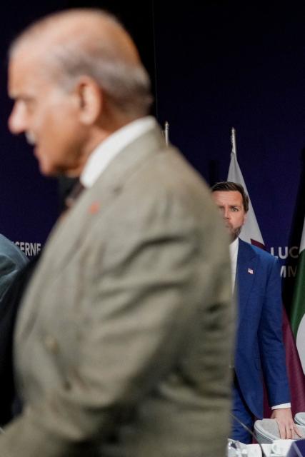 US Vice President JD Vance looks on behind Pakistan's Prime Minister Shehbaz Sharif prior to a quadrilateral meeting between the United States, Iran, Pakistan and Qatar at the Burgenstock luxury hotel complex overlooking Lake Lucerne, Switzerland, on June 21, 2026, as part of high-level talks aimed at advancing a deal to end the Middle East conflict. A new round of negotiations over the Middle East war was set to kick off on June 21, 2026 with Iranian negotiators arriving in the Swiss host city hours ahead of US Vice President JD Vance, even as Tehran said it was closing the Strait of Hormuz again over Israeli attacks in Lebanon. (Photo by Nathan Howard / POOL / AFP)