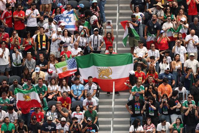 Iranian fans show pre-revolutionary Iranian flags during the 2026 World Cup Group G football match between Belgium and Iran at the Los Angeles Stadium in Inglewood on June 21, 2026.  (Photo by Etienne Laurent / AFP)