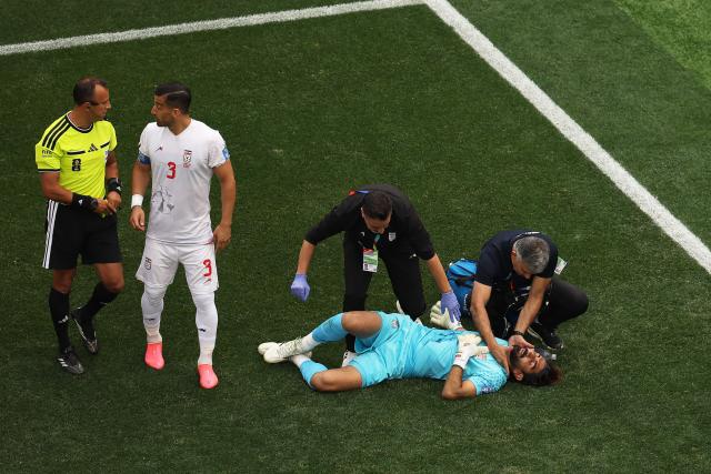 Iran's goalkeeper #01 Alireza Beiranvand receives medical attention during the 2026 World Cup Group G football match between Belgium and Iran at the Los Angeles Stadium in Inglewood on June 21, 2026.  (Photo by Etienne Laurent / AFP)