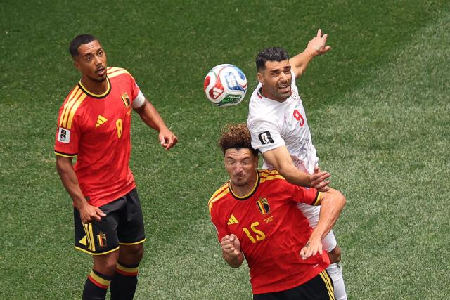 Belgium's defender #15 Thomas Meunier and Iran's forward #09 Mehdi Taremi fight for the ball next to Belgium's midfielder #08 Youri Tielemans during the 2026 World Cup Group G football match between Belgium and Iran at the Los Angeles Stadium in Inglewood on June 21, 2026.  (Photo by Etienne Laurent / AFP)