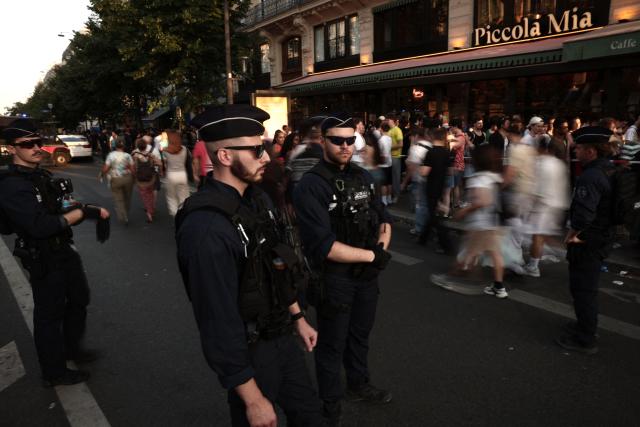 French police officers stand in the street near Place de la République during the annual street music festival 'Fete de la Musique' in Paris on June 21, 2026. (Photo by Guillaume BAPTISTE / AFP)