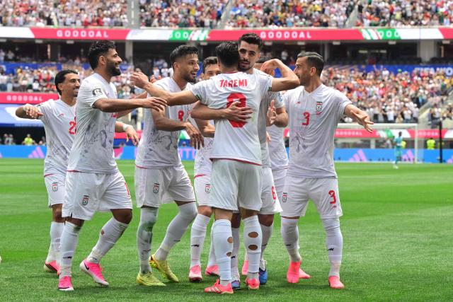 Iran's forward #09 Mehdi Taremi celebrates with teammates a goal which was later disallowed after a VAR review during the 2026 World Cup Group G football match between Belgium and Iran at the Los Angeles Stadium in Inglewood on June 21, 2026.  (Photo by Frederic J. Brown / AFP)