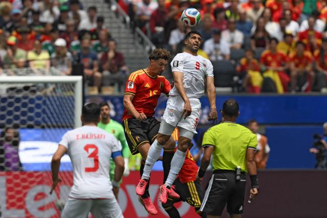 Belgium's defender #15 Thomas Meunier and Iran's forward #09 Mehdi Taremi fight for the ball during the 2026 World Cup Group G football match between Belgium and Iran at the Los Angeles Stadium in Inglewood on June 21, 2026.  (Photo by Patrick T. Fallon / AFP)