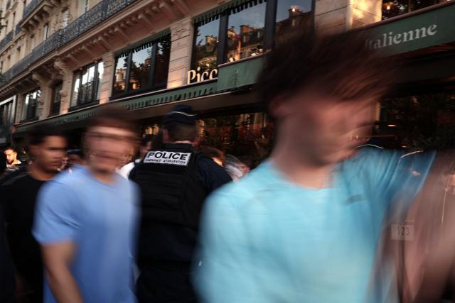 French police officers stand in the street near Place de la République during the annual street music festival 'Fete de la Musique' in Paris on June 21, 2026. (Photo by Guillaume BAPTISTE / AFP)