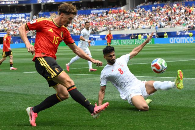 Belgium's defender #15 Thomas Meunier and Iran's midfielder #08 Mohammad Mohebbi fight for the ball during the 2026 World Cup Group G football match between Belgium and Iran at the Los Angeles Stadium in Inglewood on June 21, 2026.  (Photo by Patrick T. Fallon / AFP)