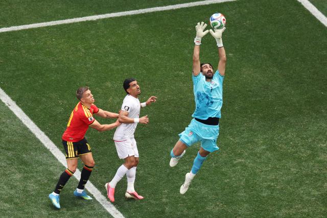 Iran's midfielder #07 Alireza Jahanbakhsh makes a save next to Belgium's forward #10 Leandro Trossard and Iran's defender #02 Saleh Hardani during the 2026 World Cup Group G football match between Belgium and Iran at the Los Angeles Stadium in Inglewood on June 21, 2026.  (Photo by Etienne Laurent / AFP)