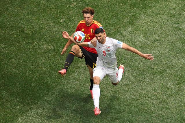 Belgium's defender #15 Thomas Meunier and Iran's forward #09 Mehdi Taremi fight for the ball during the 2026 World Cup Group G football match between Belgium and Iran at the Los Angeles Stadium in Inglewood on June 21, 2026.  (Photo by Etienne Laurent / AFP)