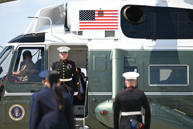 US President Donald Trump is seen on his phone as he arrives aboard Marine One at Joint Base Andrews, Maryland on June 21, 2026. Trump is returning to the White House from Camp David. (Photo by Kent NISHIMURA / AFP)