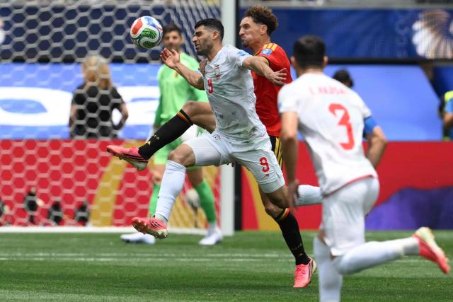 Iran's forward #09 Mehdi Taremi and Belgium's defender #15 Thomas Meunier fight for the ball during the 2026 World Cup Group G football match between Belgium and Iran at the Los Angeles Stadium in Inglewood on June 21, 2026.  (Photo by Patrick T. Fallon / AFP)