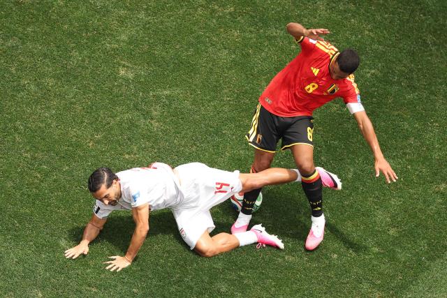 Iran's midfielder #14 Saman Ghoddos is fouled by Belgium's midfielder #08 Youri Tielemans during the 2026 World Cup Group G football match between Belgium and Iran at the Los Angeles Stadium in Inglewood on June 21, 2026.  (Photo by Etienne Laurent / AFP)