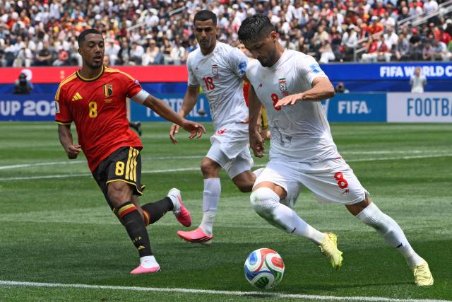 Belgium's midfielder #08 Youri Tielemans and Iran's midfielder #08 Mohammad Mohebbi fight for the ball during the 2026 World Cup Group G football match between Belgium and Iran at the Los Angeles Stadium in Inglewood on June 21, 2026.  (Photo by Patrick T. Fallon / AFP)