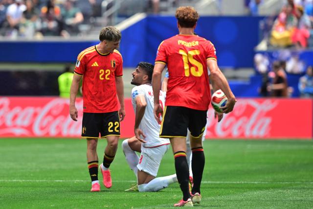 Belgium's forward #22 Alexis Saelemaekers and Iran's midfielder #08 Mohammad Mohebbi react during the 2026 World Cup Group G football match between Belgium and Iran at the Los Angeles Stadium in Inglewood on June 21, 2026.  (Photo by Frederic J. Brown / AFP)