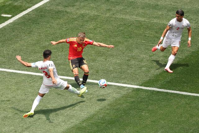 Iran's midfielder #08 Mohammad Mohebbi and Belgium's forward #10 Leandro Trossard fight for the ball next to Iran's defender #02 Saleh Hardani during the 2026 World Cup Group G football match between Belgium and Iran at the Los Angeles Stadium in Inglewood on June 21, 2026.  (Photo by Etienne Laurent / AFP)