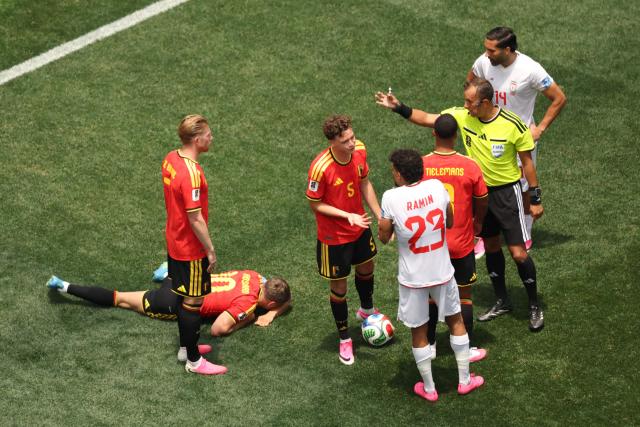 Belgium's forward #10 Leandro Trossard reacts in pain as Argentine referee Dario Herrera gestures next to Belgium's defender #05 Maxim De Cuyper, Iran's defender #23 Ramin Rezaeian, Belgium's midfielder #08 Youri Tielemans and Iran's midfielder #14 Saman Ghoddos during the 2026 World Cup Group G football match between Belgium and Iran at the Los Angeles Stadium in Inglewood on June 21, 2026.  (Photo by Etienne Laurent / AFP)