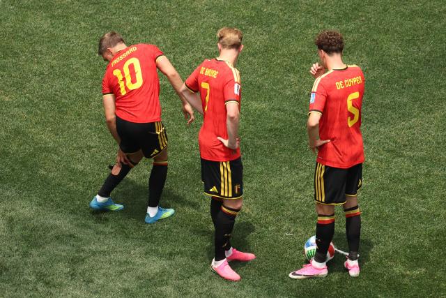 Belgium's forward #10 Leandro Trossard reacts in pain after a foul next to teammates midfielder #07 Kevin De Bruyne and defender #05 Maxim De Cuyper during the 2026 World Cup Group G football match between Belgium and Iran at the Los Angeles Stadium in Inglewood on June 21, 2026.  (Photo by Etienne Laurent / AFP)