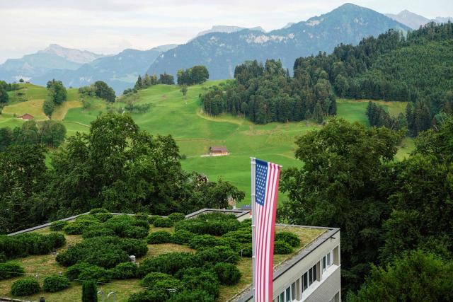 This photograph shows A U.S. flag displayed at the Burgenstock luxury hotel complex overlooking Lake Lucerne, Switzerland, on the day of talks between the U.S., Iran, Pakistan, and Qatar at the Lake Lucerne, Switzerland, on June 21, 2026, as part of high-level talks aimed at advancing a deal to end the Middle East conflict. A new round of negotiations over the Middle East war was set to kick off on June 21, 2026 with Iranian negotiators arriving in the Swiss host city hours ahead of US Vice President JD Vance, even as Tehran said it was closing the Strait of Hormuz again over Israeli attacks in Lebanon. (Photo by Nathan Howard / POOL / AFP)