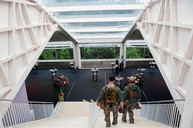 Secret Service police members walk down the stairs at the Burgenstock luxury hotel complex overlooking Lake Lucerne, Switzerland, on the day of talks between the U.S., Iran, Pakistan, and Qatar at the Lake Lucerne, Switzerland, on June 21, 2026, as part of high-level talks aimed at advancing a deal to end the Middle East conflict. A new round of negotiations over the Middle East war was set to kick off on June 21, 2026 with Iranian negotiators arriving in the Swiss host city hours ahead of US Vice President JD Vance, even as Tehran said it was closing the Strait of Hormuz again over Israeli attacks in Lebanon. (Photo by Nathan Howard / POOL / AFP)