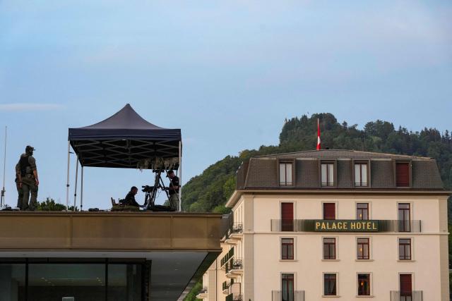 A U.S. Secret Service agent walks the grounds of the Burgenstock luxury hotel complex overlooking Lake Lucerne, Switzerland, on the day of talks between the U.S., Iran, Pakistan, and Qatar at the Lake Lucerne, Switzerland, on June 21, 2026, as part of high-level talks aimed at advancing a deal to end the Middle East conflict. A new round of negotiations over the Middle East war was set to kick off on June 21, 2026 with Iranian negotiators arriving in the Swiss host city hours ahead of US Vice President JD Vance, even as Tehran said it was closing the Strait of Hormuz again over Israeli attacks in Lebanon. (Photo by Nathan Howard / POOL / AFP)