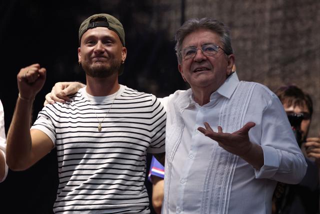 Founder of French left-wing party La France Insoumise (LFI) Jean-Luc Melenchon and La France Insoumise - Nouveau Front Populaire's MP Raphael Arnault pose on stage during a concert organised by French left-wing La France Insoumise (LFI) party as part of the annual street music festival 'Fete de la Musique' in Paris on June 21, 2026. (Photo by Guillaume BAPTISTE / AFP)