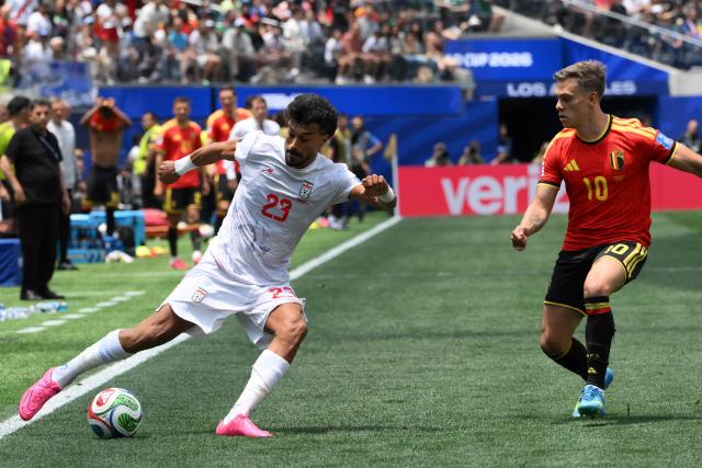 Iran's defender #23 Ramin Rezaeian and Belgium's forward #10 Leandro Trossard fight for the ball during the 2026 World Cup Group G football match between Belgium and Iran at the Los Angeles Stadium in Inglewood on June 21, 2026.  (Photo by Patrick T. Fallon / AFP)