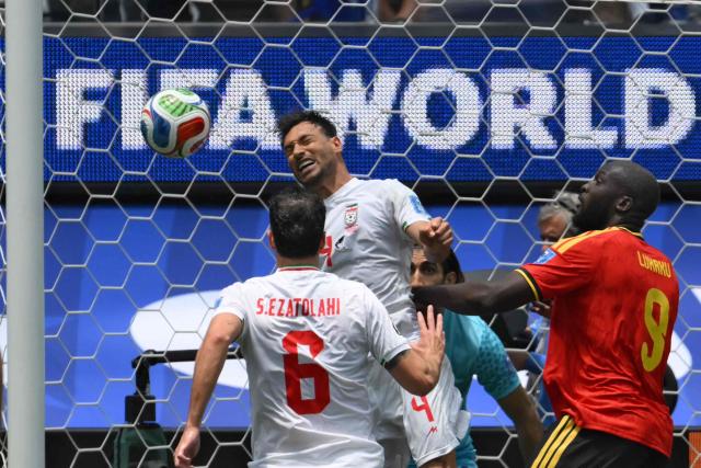 Iran's defender #04 Shojae Khalilzadeh and Belgium's forward #09 Romelu Lukaku fight for the ball during the 2026 World Cup Group G football match between Belgium and Iran at the Los Angeles Stadium in Inglewood on June 21, 2026.  (Photo by Patrick T. Fallon / AFP)