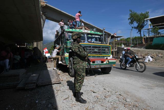 A soldier stands guard along the Pan-American highway near a polling station in Santander de Quilichao, Cauca department, Colombia, during the presidential runoff election on June 21, 2026. (Photo by JOAQUIN SARMIENTO / AFP)