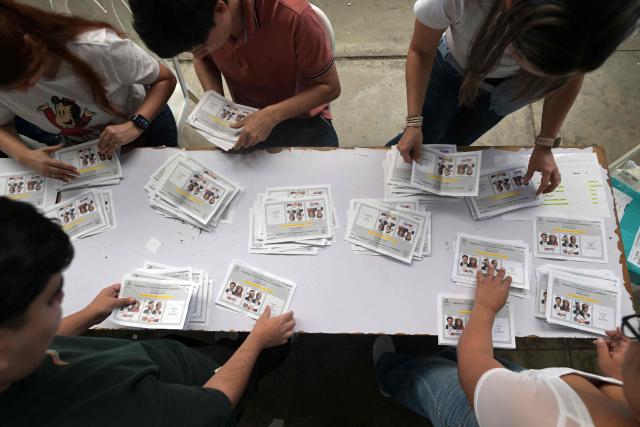 Electoral officials count votes during the presidential election runoff in Cali, Colombia, on June 21, 2026. Colombians voted on June 21 in a polarized presidential runoff that could reshape the country's fragile peace process and relations with the United States, after the most violent election campaign in a decade. (Photo by JOAQUIN SARMIENTO / AFP)