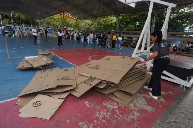 An electoral official organizes unused voting materials during the presidential election runoff in Barranquilla, Colombia, on June 21, 2026. Colombians voted on June 21 in a polarized presidential runoff that could reshape the country's fragile peace process and relations with the United States, after the most violent election campaign in a decade. (Photo by Vanexa Romero / AFP)