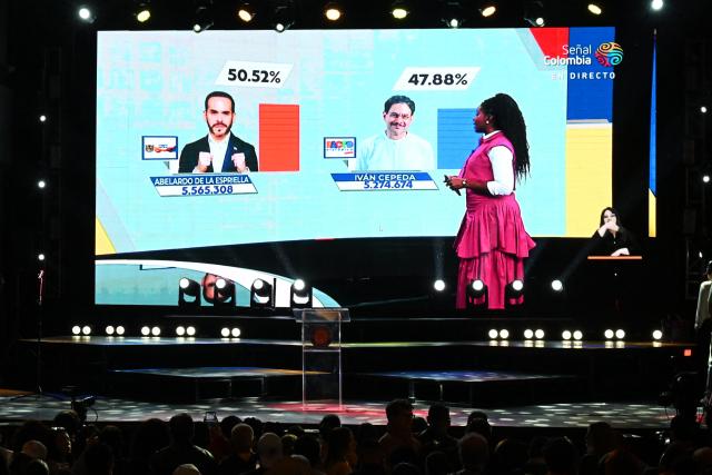 Supporters of Colombia's presidential candidate for the ruling Pacto Historico party Ivan Cepeda watch partial results displayed on a screen during the presidential runoff election at the Tequendama Hotel in Bogota on June 21, 2026. Colombians voted on June 21 in a polarized presidential runoff that could reshape the country's fragile peace process and relations with the United States, after the most violent election campaign in a decade. (Photo by Raul ARBOLEDA / AFP)