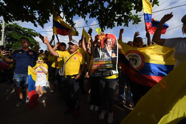 Supporters of Colombia's presidential candidate for the Defensores de la Patria movement, Abelardo de la Espriella, react after the first results of the presidential election runoff at the Ventana al Mundo monument in Barranquilla, Colombia, on June 21, 2026. Colombians voted on June 21 in a polarized presidential runoff that could reshape the country's fragile peace process and relations with the United States, after the most violent election campaign in a decade. (Photo by Jaime SALDARRIAGA / AFP)