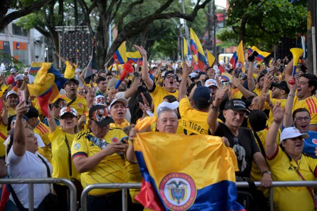 Supporters of Colombia's presidential candidate for the Defensores de la Patria movement Abelardo de la Espriella react as they watch partial results displayed on a screen during the presidential runoff election in Cali, Colombia, on June 21, 2026. Colombians voted on June 21 in a polarized presidential runoff that could reshape the country's fragile peace process and relations with the United States, after the most violent election campaign in a decade. (Photo by JOAQUIN SARMIENTO / AFP)