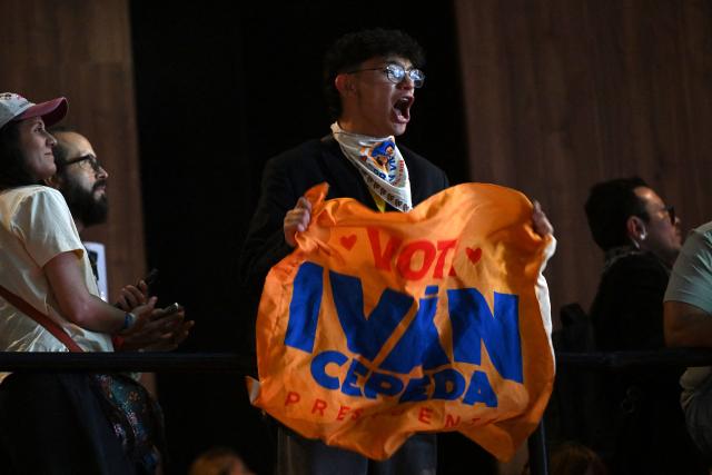 Supporters of Colombia's presidential candidate for the ruling Pacto Historico party Ivan Cepeda react as they watch partial results displayed on a screen during the presidential runoff election at the Tequendama Hotel in Bogota on June 21, 2026. Colombians voted on June 21 in a polarized presidential runoff that could reshape the country's fragile peace process and relations with the United States, after the most violent election campaign in a decade. (Photo by Raul ARBOLEDA / AFP)