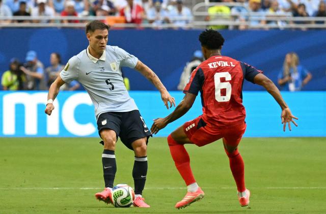 Uruguay's midfielder #05 Manuel Ugarte and Cape Verde's midfielder #06 Kevin Pina fight for the ball during the 2026 World Cup Group H football match between Uruguay and Cape Verde at the Miami Stadium in Miami Gardens on June 21, 2026.  (Photo by CHANDAN KHANNA / AFP)