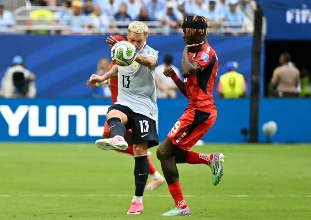 Uruguay's defender #13 Guillermo Varela and Cape Verde's forward #09 Gilson Benchimol fight for the ball during the 2026 World Cup Group H football match between Uruguay and Cape Verde at the Miami Stadium in Miami Gardens on June 21, 2026.  (Photo by CHANDAN KHANNA / AFP)