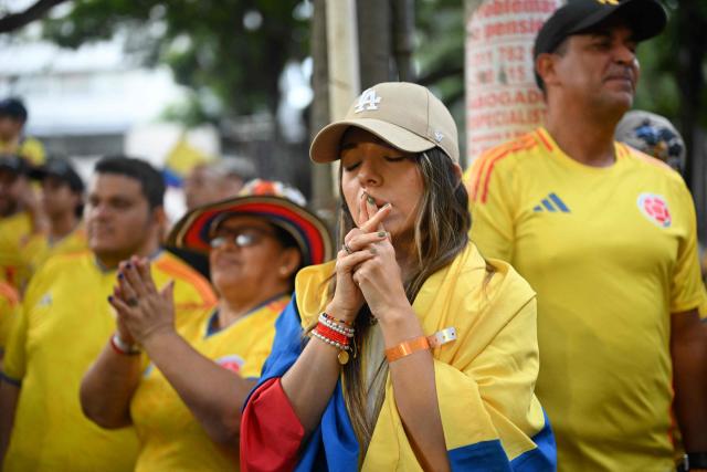 A supporter of Colombia's presidential candidate for the Defensores de la Patria movement Abelardo de la Espriella reacts as partial results are displayed on a screen during the presidential runoff election in Cali, Colombia, on June 21, 2026. Colombians voted on June 21 in a polarized presidential runoff that could reshape the country's fragile peace process and relations with the United States, after the most violent election campaign in a decade. (Photo by Joaquin SARMIENTO / AFP)