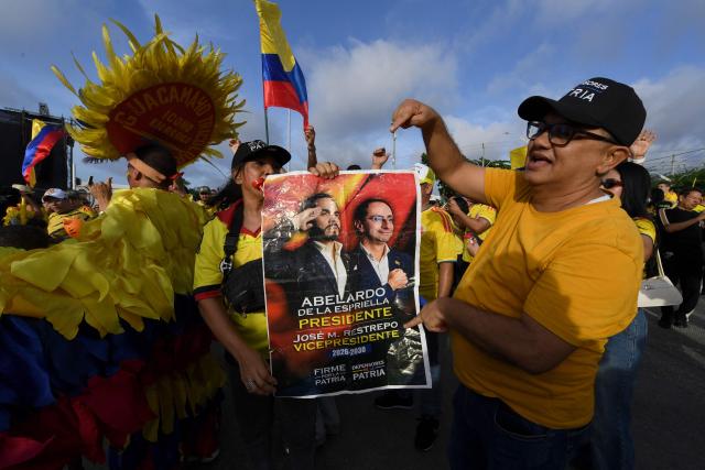 Supporters of Colombia's presidential candidate for the Defensores de la Patria movement, Abelardo de la Espriella, react after the first results of the presidential election runoff at the Ventana al Mundo monument in Barranquilla, Colombia, on June 21, 2026. Colombians voted on June 21 in a polarized presidential runoff that could reshape the country's fragile peace process and relations with the United States, after the most violent election campaign in a decade. (Photo by Jaime SALDARRIAGA / AFP)