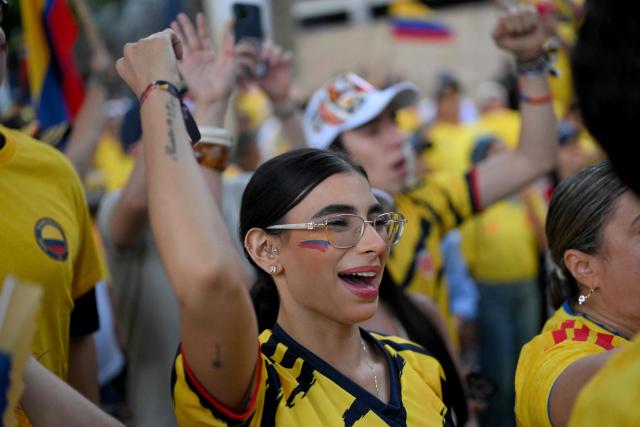 A supporter of Colombia's presidential candidate for the Defensores de la Patria movement Abelardo de la Espriella reacts as partial results are displayed on a screen during the presidential runoff election in Cali, Colombia, on June 21, 2026. Colombians voted on June 21 in a polarized presidential runoff that could reshape the country's fragile peace process and relations with the United States, after the most violent election campaign in a decade. (Photo by Joaquin SARMIENTO / AFP)