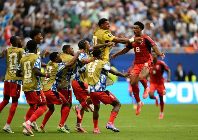 Cape Verde's midfielder #06 Kevin Pina celebrates with teammates after scoring his team's first goal during the 2026 World Cup Group H football match between Uruguay and Cape Verde at the Miami Stadium in Miami Gardens on June 21, 2026.  (Photo by CHANDAN KHANNA / AFP)