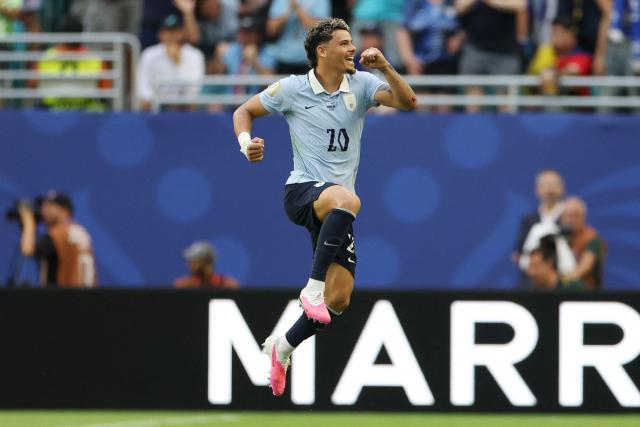 Uruguay's midfielder #20 Maximiliano Araujo celebrates scoring his team's first goal during the 2026 World Cup Group H football match between Uruguay and Cape Verde at the Miami Stadium in Miami Gardens on June 21, 2026.  (Photo by PATRICIA DE MELO MOREIRA / AFP)