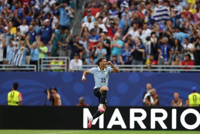 Uruguay's midfielder #20 Maximiliano Araujo celebrates scoring his team's first goal during the 2026 World Cup Group H football match between Uruguay and Cape Verde at the Miami Stadium in Miami Gardens on June 21, 2026.  (Photo by PATRICIA DE MELO MOREIRA / AFP)