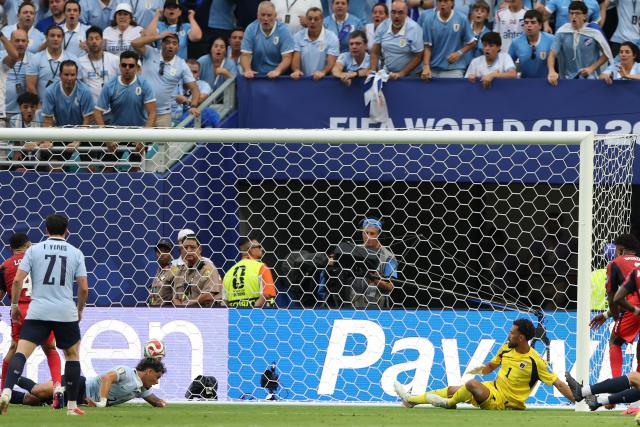 Uruguay's midfielder #20 Maximiliano Araujo heads the ball and scores his team's first goal during the 2026 World Cup Group H football match between Uruguay and Cape Verde at the Miami Stadium in Miami Gardens on June 21, 2026.  (Photo by PATRICIA DE MELO MOREIRA / AFP)