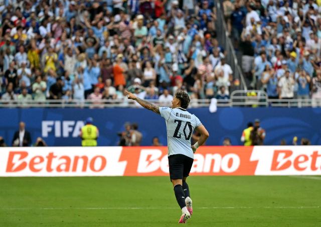 Uruguay's midfielder #20 Maximiliano Araujo celebrates after scoring his team's first goal during the 2026 World Cup Group H football match between Uruguay and Cape Verde at the Miami Stadium in Miami Gardens on June 21, 2026.  (Photo by CHANDAN KHANNA / AFP)
